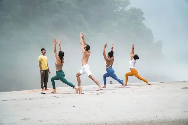 Group of people practicing yoga at the Ganges